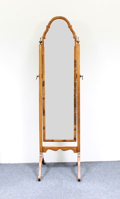 Lot 175 - A walnut arch top cheval glass on splay feet,...