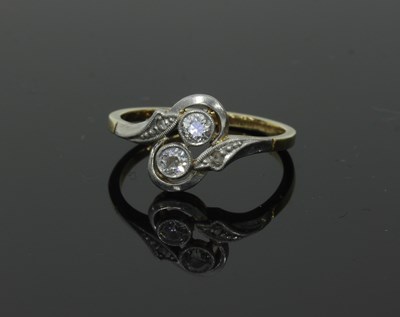 Lot 53 - A two-stone diamond ring, in crossover type...