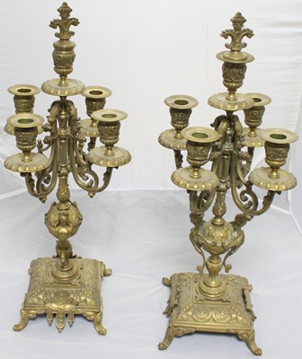 Lot 902 - A pair of brass five-light candelabrum each...