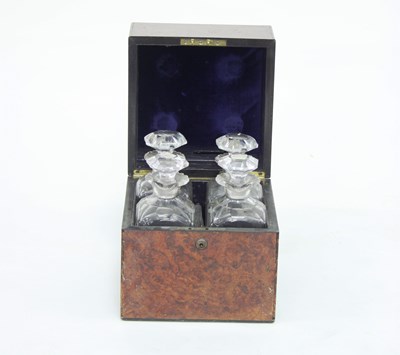 Lot 920 - A walnut decanter box containing four cut...