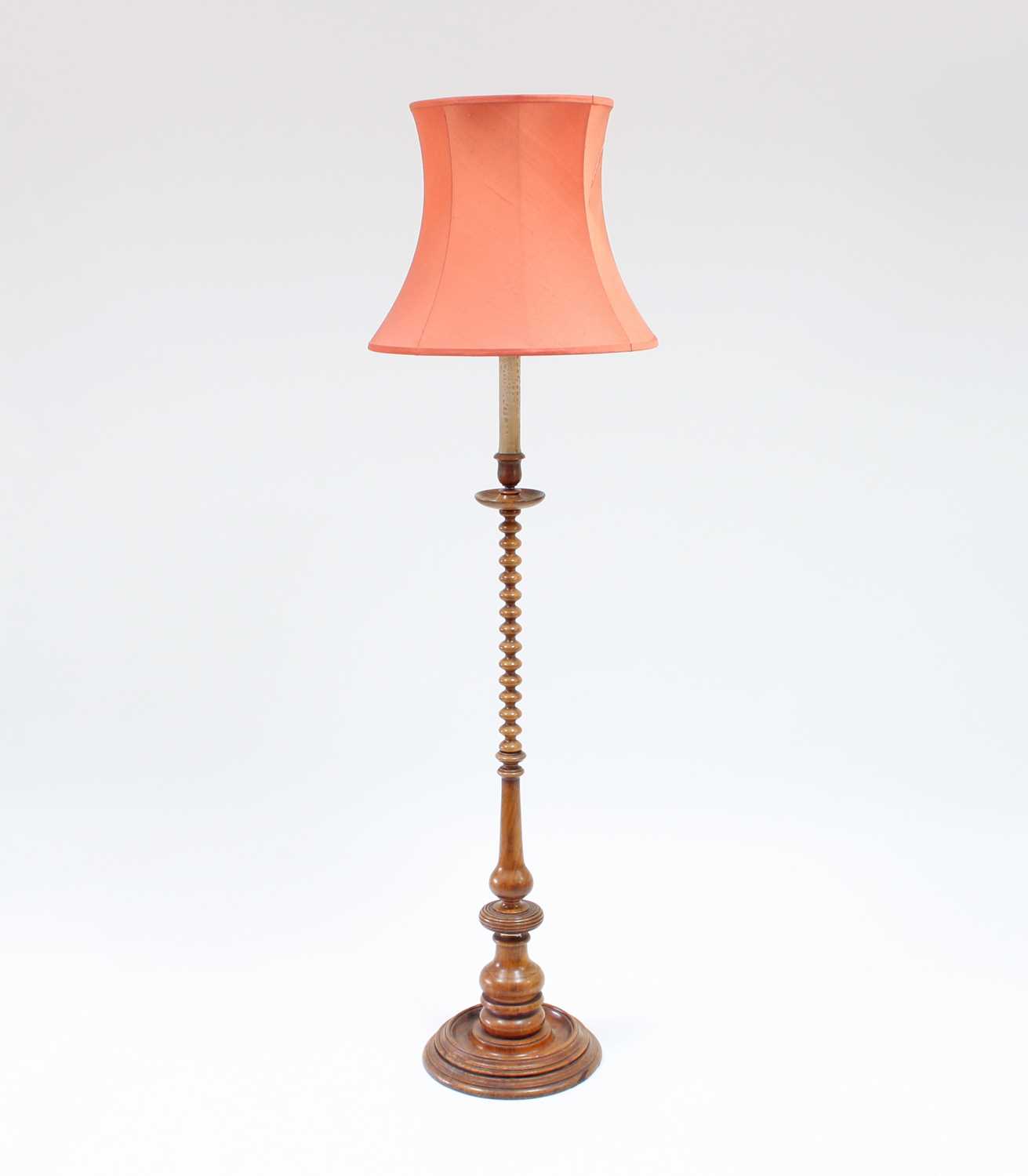 Lot 101 - A turned walnut candlestick with bobbin turned...