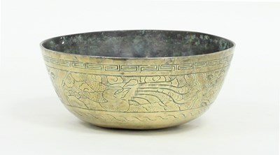 Lot 432 - A Chinese circular brass bowl engraved a band...