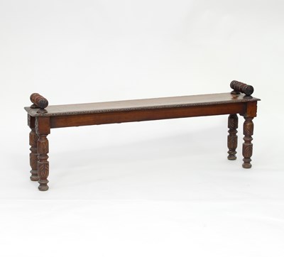 Lot 272 - A carved oak bench with turned handles and...