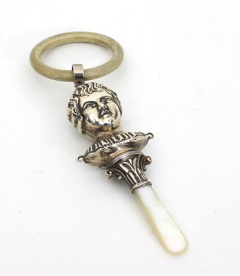 Lot 470 - A child's silver teether, chased as a child's...