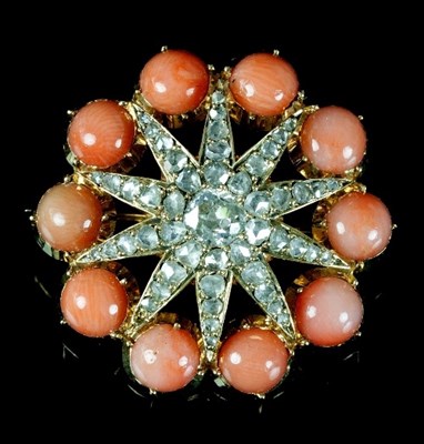 Lot 488 - A coral and diamond brooch, the central...