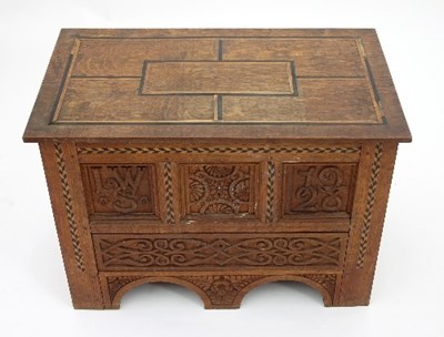 Lot 9 - An Arts and Crafts oak mule chest of small...