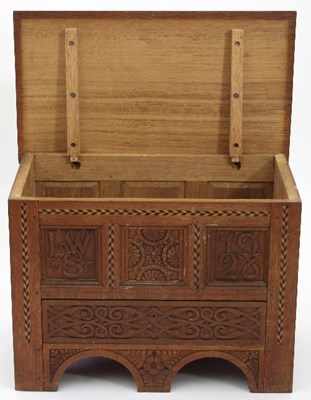 Lot 9 - An Arts and Crafts oak mule chest of small...