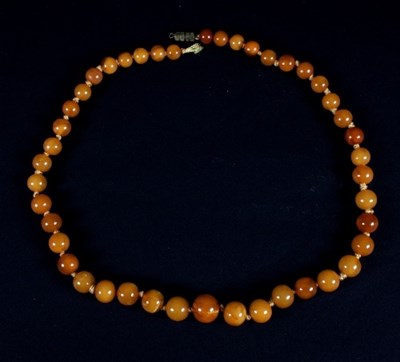 Lot 454 - An amber bead necklace, the forty-four...
