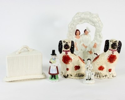 Lot 62 - A Staffordshire porcelain figure of a man with...