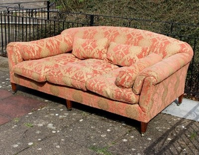 Lot 659 - A large upholstered sofa on three tapering...