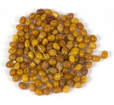 Lot 558 - A quantity of oval amber beads, of...