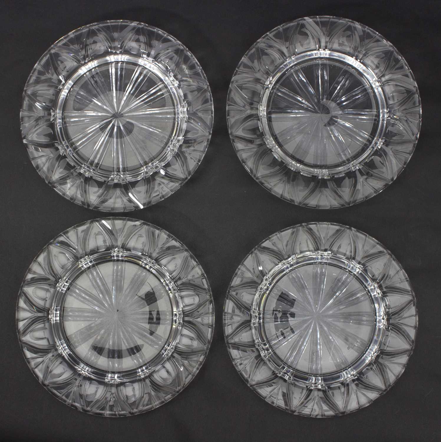 Lot 47 - A set of four clear glass plates, deeply cut...