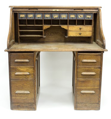 Lot 795 - An American style roll top desk with fitted...