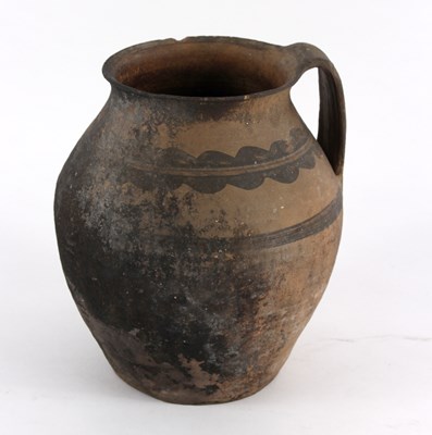 Lot 346 - An early pottery jug with red decoration,...
