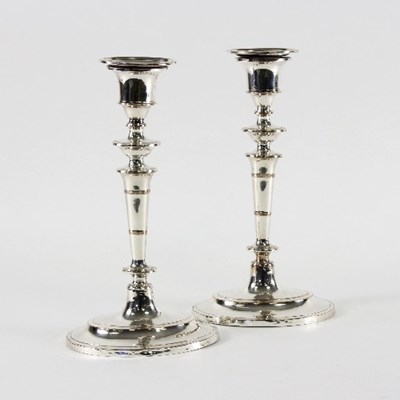 Lot 93 - A pair of Sheffield plated candlesticks of...