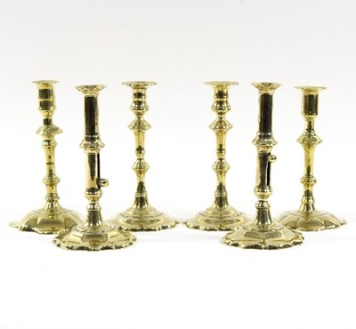Lot 318 - Two pairs of petal based brass candlesticks...