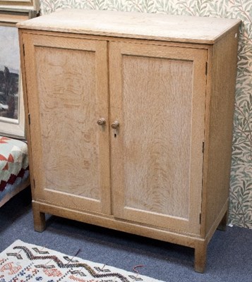 Lot 90 - A Heals bleached oak cupboard on block feet,...