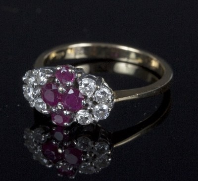 Lot 555 - A ruby and diamond dress ring, the cluster of...