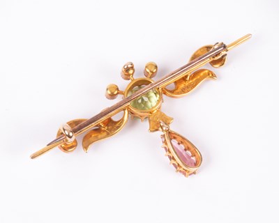 Lot 120 - An Edwardian Suffragette style 15ct yellow gold peridot, pink tourmaline and seed pearl bar brooch