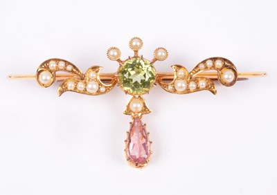 Lot 120 - An Edwardian Suffragette style 15ct yellow gold peridot, pink tourmaline and seed pearl bar brooch