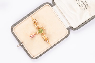 Lot 120 - An Edwardian Suffragette style 15ct yellow gold peridot, pink tourmaline and seed pearl bar brooch