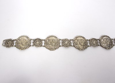 Lot 43 - A white metal belt comprising seven circles...