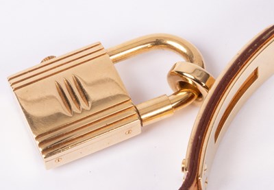 Lot 110 - A lady's Hermès Kelly gold plated quartz wristwatch