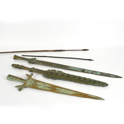 Lot 1073 - Three bronzed swords, a tribal arrow and another
