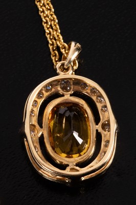 Lot 79 - An 18ct gold, diamond and yellow sapphire pendant