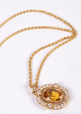 Lot 79 - An 18ct gold, diamond and yellow sapphire pendant