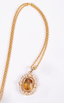 Lot 79 - An 18ct gold, diamond and yellow sapphire pendant
