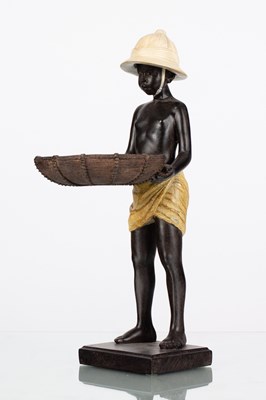 Lot 85 - A resin figure of a standing boy wearing pith...
