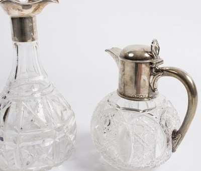Lot 57 - A spherical cut glass claret jug, the silver...