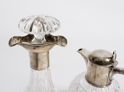 Lot 57 - A spherical cut glass claret jug, the silver...