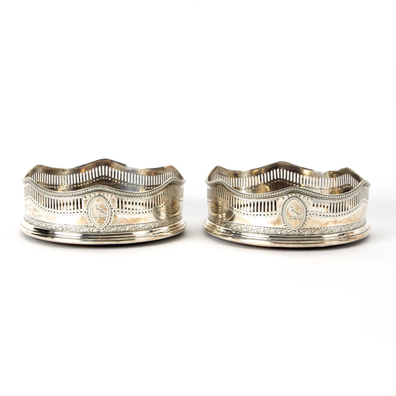 Lot 74 - A pair of George III silver wine coasters,...