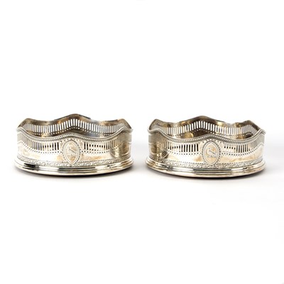 Lot 74 - A pair of George III silver wine coasters,...