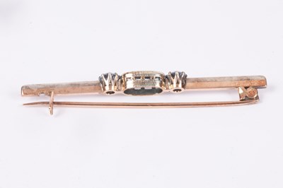 Lot 87 - An aquamarine three-stone bar brooch