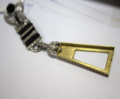 Lot 275 - A Cartier 'Egyptian' onyx and diamond lapel...