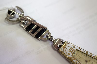 Lot 275 - A Cartier 'Egyptian' onyx and diamond lapel...