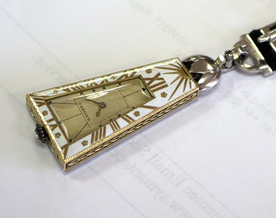Lot 275 - A Cartier 'Egyptian' onyx and diamond lapel...