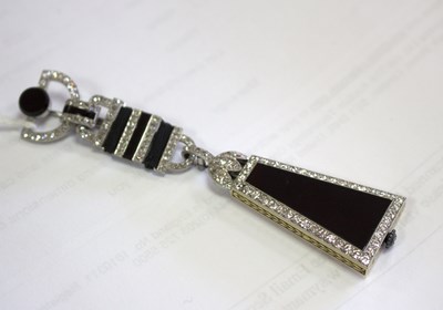 Lot 275 - A Cartier 'Egyptian' onyx and diamond lapel...