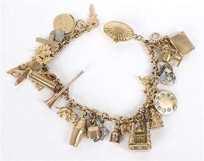 Lot 115 - A 9ct gold bracelet hung with numerous mainly...