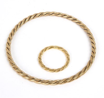 Lot 140 - A 9ct gold bangle and matching ring of...