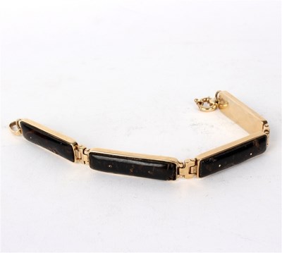Lot 187 - A 9ct gold bracelet, the four elongated...
