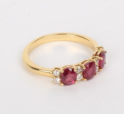 Lot 201 - A ruby and diamond ring, the three oval rubies...