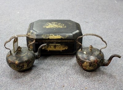 Lot 279 - An ebonised work box and two toleware tea kettles