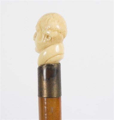Lot 498 - A walking stick with carved ivory handle in...