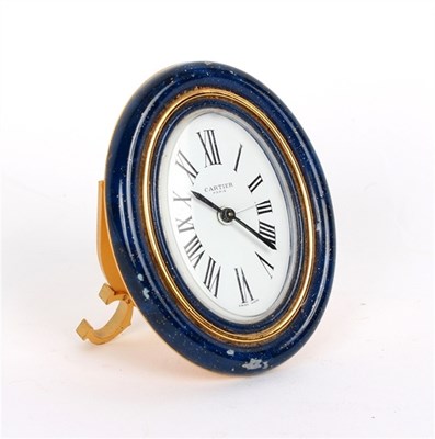Lot 848 - A Cartier alarm clock, the oval dial with...
