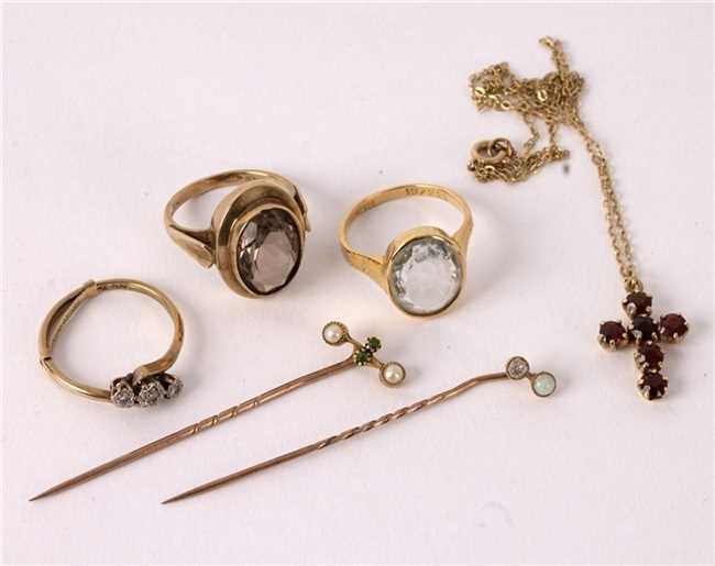 Lot 7 - A diamond three-stone ring set in 9ct gold and...