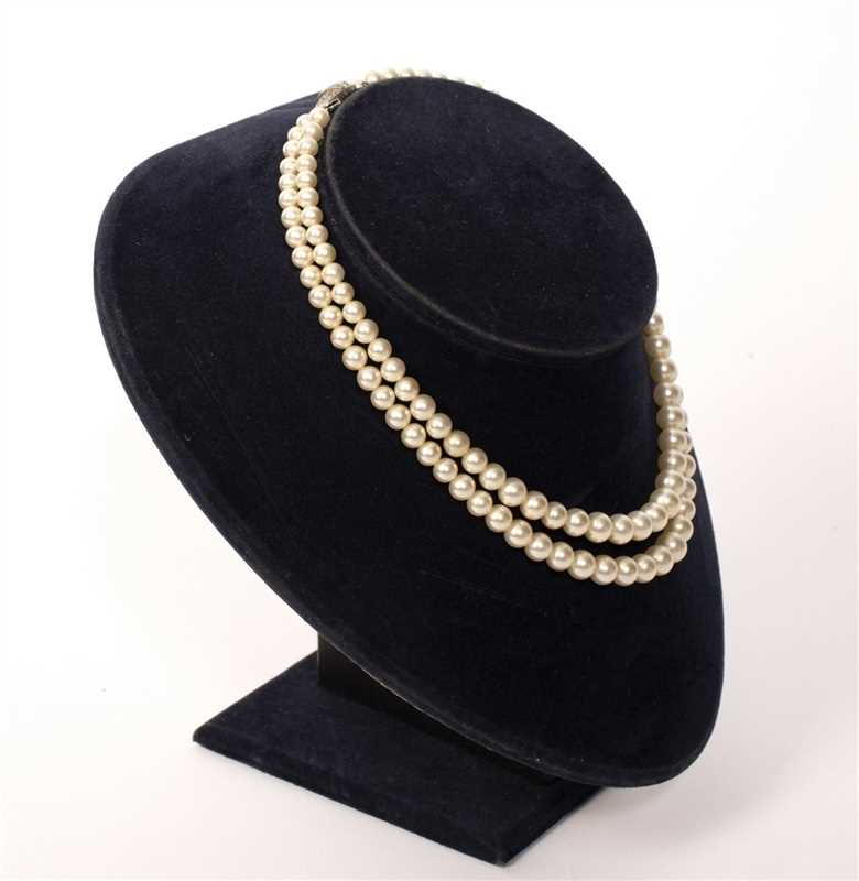 Lot 23 - A pearl and diamond cluster pendant set in 14k...